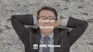 Asian executive resting while lying on bed of money and day dreaming about what passive income is all about