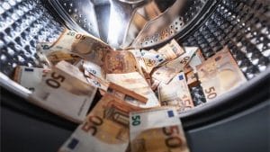 Money being washed on a washing machine - money laundering